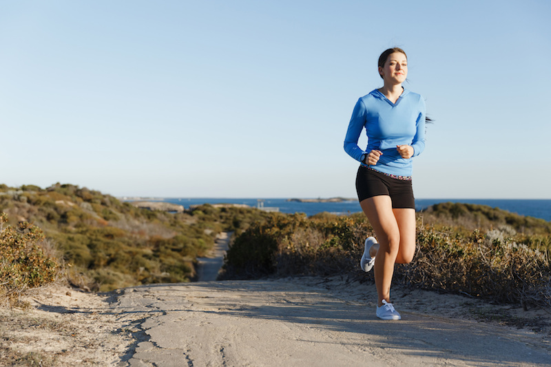 Sport runner jogging on beach working out